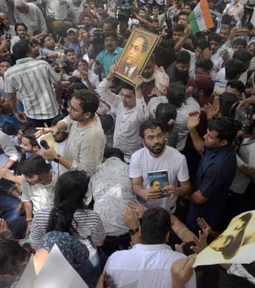 India: Cockroach Janta Party Protest in New Delhi Abhijeet Dipke, head of the Cockroach Janta Party (CJP), during a protest shows a copy of a book authored by Bhimrao Ambedkar, considered the father of Indian Constitution. School students, college-goers, competitive exam aspirants and parents were among those who gathered for a protest organized by the Cockroach Janta Party (CJP), for their concerns over the education system had brought them to the demonstration. New Delhi India Copyright: SondeepxShankar