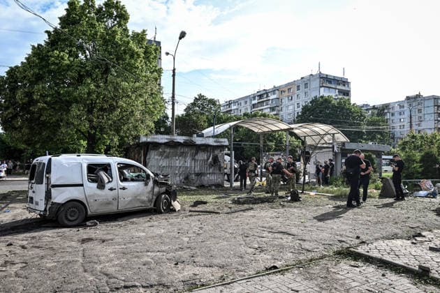 Investigative and forensic teams document damage and collect debris for examination at the site of a Russian drone strike near a public transport stop in Zaporizhzhia, Ukraine, on June 8, 2026. Russian occupation forces carried out a drone attack on the civilian infrastructure of the southeastern city. The drone hit a residential area, with the explosion occurring near a public transport stop. The blast wave and debris significantly damaged nearby apartment blocks, destroyed and damaged shopping stalls and cars. The impact claimed the lives of two women who were in the zone of the strike. Twenty-four people were injured, including five children and two teenagers. (Photo by Dmytro Smolienko Ukrinform) Deadly Russian drone attack on residenti  Copyright: xDmytroxSmolienkox