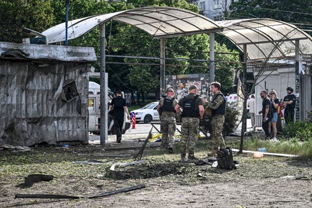 Investigative and forensic teams document damage and collect debris for examination at the site of a Russian drone strike near a public transport stop in Zaporizhzhia, Ukraine, on June 8, 2026. Russian occupation forces carried out a drone attack on the civilian infrastructure of the southeastern city. The drone hit a residential area, with the explosion occurring near a public transport stop. The blast wave and debris significantly damaged nearby apartment blocks, destroyed and damaged shopping stalls and cars. The impact claimed the lives of two women who were in the zone of the strike. Twenty-four people were injured, including five children and two teenagers. (Photo by Dmytro Smolienko Ukrinform) Deadly Russian drone attack on residenti  Copyright: xDmytroxSmolienkox
