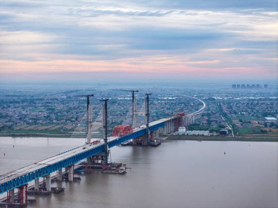 (260609) -- NANTONG, June 9, 2026 -- A drone photo taken on June 9, 2026 shows a view of the Chongqi Highway-Railway Bridge over the Yangtze River between east China s Shanghai and Jiangsu. A key project of the Shanghai-Chongqing-Chengdu high-speed railway, the Chongqi Highway-Railway Bridge was successfully closed here on Tuesday. It has a total length of 4.09 kilometers and a main span of 400 meters. Once opened to traffic, the bridge will reduce the travel time between Shanghai and Qidong of Jiangsu from two and a half hours to less than half an hour. ) CHINA-SHANGHAI-JIANGSU-CHONGQI HIGHWAY-RAILWAY BRIDGE OVER YANGTZE RIVER (CN) JixChunpeng 