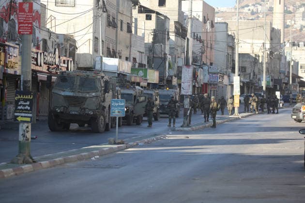 Palestinian - Israeli conflict in Nablus, Palestine - 09 Jun 2026 Israeli soldiers guard military vehicles as they raid homes during a military operation in the Askar refugee camp. Israeli forces raided and searched Palestinian homes as part of a large-scale search and arrest operation that included the Ras al-Ain area, the Old City, and the Askar refugee camp. Palestinians reported that five Palestinians were arrested during the operation. Nablus Palestine Copyright: xNasserxishatyehx xSOPAxImagesx Nishtayeh2228