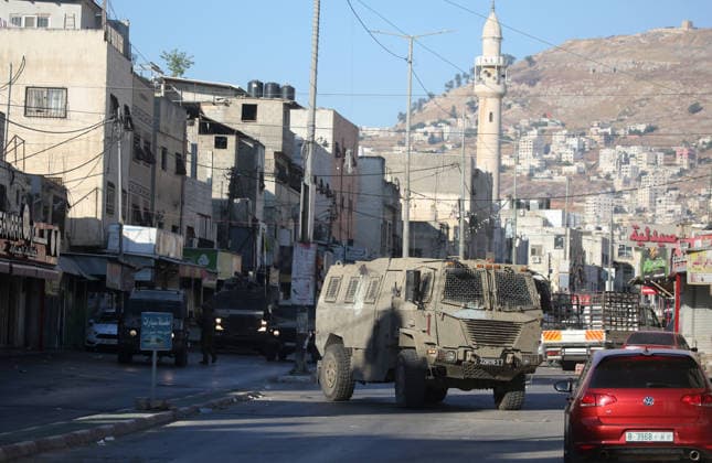 Palestinian - Israeli conflict in Nablus, Palestine - 09 Jun 2026 An Israeli military armored personnel carrier seen blocking a road during a military operation in the Askar refugee camp. Israeli forces raided and searched Palestinian homes as part of a large-scale search and arrest operation that included the Ras al-Ain area, the Old City, and the Askar refugee camp. Palestinians reported that five Palestinians were arrested during the operation. Nablus Palestine Copyright: xNasserxishatyehx xSOPAxImagesx Nishtayeh2229