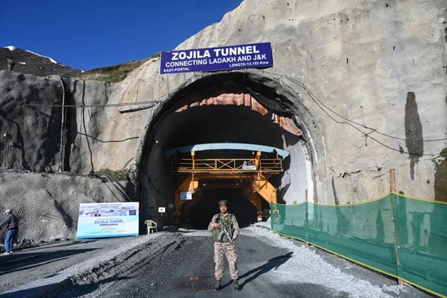 DRASS, INDIA - JUNE 9: A Paramilitary soldier stands guard at East Portal of Zojila Tunnel after the historic breakthrough ceremony of the Zojila Tunnel at Meenamarg on June 9, 2026 in Drass, India. Build at the cost of Rs 6000 Cr. the 13.15 KM tunnel is now the world s longest single-tube, bi-directional road tunnel at an elevation exceeding 11,500 feet. The historic breakthrough brings a decades-old national security dream closer to reality. For generations, the treacherous Zojila Pass on National Highway 1 (NH-1) has functioned as a severe logistical bottleneck, shutting down completely for three to four months during peak winter due to heavy avalanches, massive snow accumulation, and sub-zero structural icing.(Photo by Waseem Andrabi H