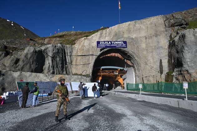 DRASS, INDIA - JUNE 9: A Paramilitary soldier stands guard at East Portal of Zojila Tunnel after the historic breakthrough ceremony of the Zojila Tunnel at Meenamarg on June 9, 2026 in Drass, India. Build at the cost of Rs 6000 Cr. the 13.15 KM tunnel is now the world s longest single-tube, bi-directional road tunnel at an elevation exceeding 11,500 feet. The historic breakthrough brings a decades-old national security dream closer to reality. For generations, the treacherous Zojila Pass on National Highway 1 (NH-1) has functioned as a severe logistical bottleneck, shutting down completely for three to four months during peak winter due to heavy avalanches, massive snow accumulation, and sub-zero structural icing.(Photo by Waseem Andrabi H