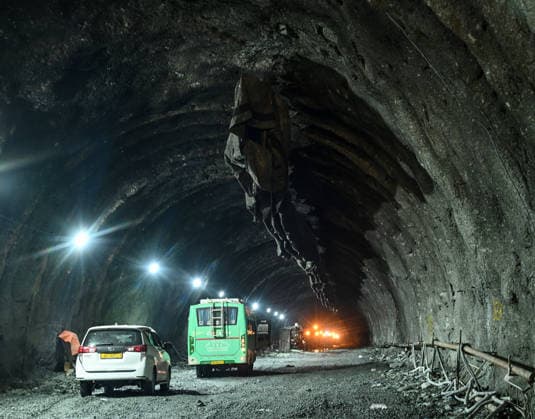 DRASS, INDIA - JUNE 9: Vehicles drive through the Zojila Tunnel following its breakthrough ceremony at Meenamarg on June 9, 2026 in Drass, India. Build at the cost of Rs 6000 Cr. the 13.15 KM tunnel is now the world s longest single-tube, bi-directional road tunnel at an elevation exceeding 11,500 feet. The historic breakthrough brings a decades-old national security dream closer to reality. For generations, the treacherous Zojila Pass on National Highway 1 (NH-1) has functioned as a severe logistical bottleneck, shutting down completely for three to four months during peak winter due to heavy avalanches, massive snow accumulation, and sub-zero structural icing.(Photo by Waseem Andrabi Hindustan Times) Union Minister For Road Transport And