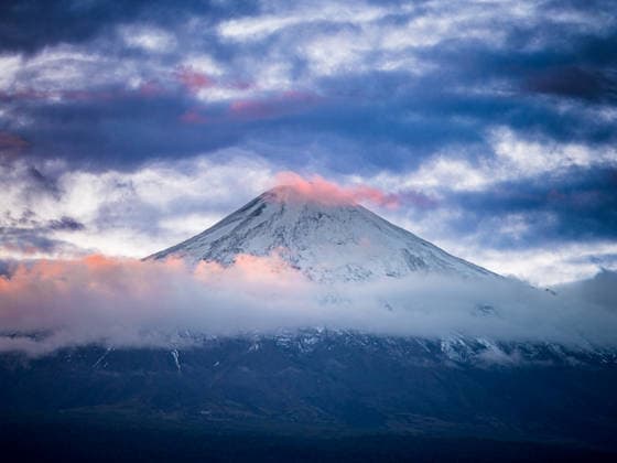 Snowy volcano peak with moody twilight clouds Pucón, Araucania, Chile CR_EVVA260528-2039279-01