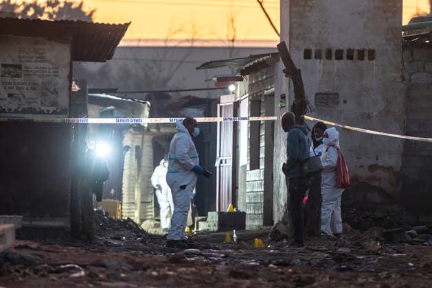 (260610) -- JOHANNESBURG, June 10, 2026 -- People work at the scene of a shooting incident in Cleveland, Johannesburg, South Africa, June 10, 2026. At least 12 people were killed and nine others injured in a mass shooting at an informal settlement in Johannesburg, South Africa s largest city, police said on Wednesday. (Photo by Shiraaz Mohamed Xinhua) SOUTH AFRICA-JOHANNESBURG-SHOOTING INCIDENT ChenxWei 