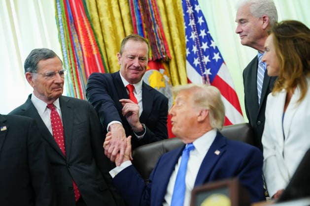 Senator Eric Schmitt, a Republican of Missouri, second left, and US President Donald Trump shake hands during a signing ceremony for the Secure America Act in the Oval Office of the White House in Washington, DC, US, on Wednesday, June 10, 2026. President Donald Trump prevailed after dissident Republican lawmakers abandoned an effort to leverage a $70 billion spending package to prevent him from reviving a payout fund for political allies who say they were unfairly targeted by the Biden administration.  WAX20260610205 AaronxSchwartz