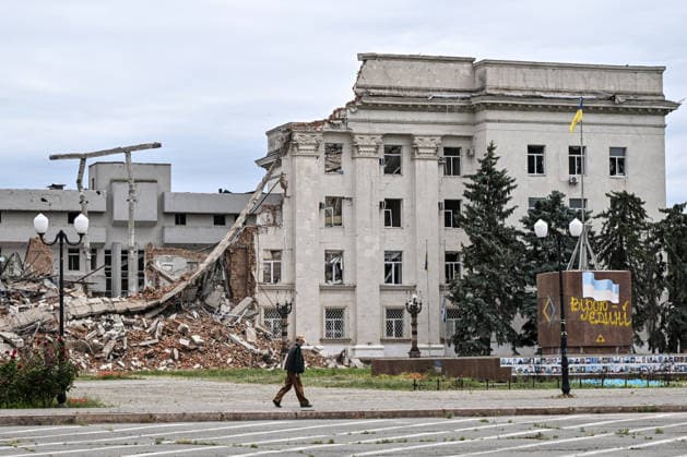 RECORD DATE NOT STATED A man walks past the destroyed building of the Kherson Regional Military Administration in the red zone of the frontline city of Kherson, the area considered the most dangerous due to constant Russian attacks, Kherson, Ukraine, on June 3, 2026. The Russian army attacks the city daily with FPV drones and other unmanned aerial vehicles, deliberately terrorizing civilians. Russian forces conduct hunts for local residents, tracking them with FPV drones and dropping explosives. Police officers, medics, public transport, and urban infrastructure are also targeted. Based on the intensity of attacks, Kherson is informally divided into yellow and red zones, with the red zone subjected to continuous shelling and drone strikes. Anti-drone ne  Copyright: xDmytroxSmolienkox