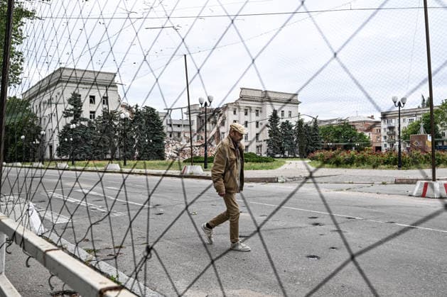 RECORD DATE NOT STATED A man walks along a road covered with anti-drone netting installed to protect against Russian FPV drones in the red zone of the frontline city of Kherson, the area considered the most dangerous due to constant Russian attacks, Kherson, Ukraine, on June 3, 2026. The Russian army attacks the city daily with FPV drones and other unmanned aerial vehicles, deliberately terrorizing civilians. Russian forces conduct hunts for local residents, tracking them with FPV drones and dropping explosives. Police officers, medics, public transport, and urban infrastructure are also targeted. Based on the intensity of attacks, Kherson is informally divided into yellow and red zones, with the red zone subjected to continuous shelling and drone strik  Copyright: xDmytroxSmolienkox