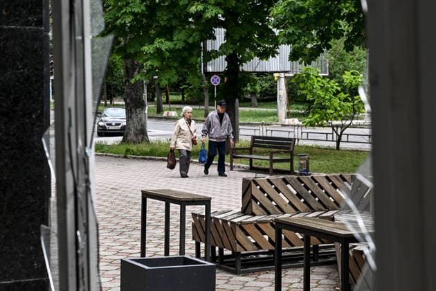 RECORD DATE NOT STATED Lone pedestrians are seen through a shattered storefront window in the red zone of the frontline city of Kherson, the area considered the most dangerous due to constant Russian attacks, Kherson, Ukraine, on June 3, 2026. The Russian army attacks the city daily with FPV drones and other unmanned aerial vehicles, deliberately terrorizing civilians. Russian forces conduct hunts for local residents, tracking them with FPV drones and dropping explosives. Police officers, medics, public transport, and urban infrastructure are also targeted. Based on the intensity of attacks, Kherson is informally divided into yellow and red zones, with the red zone subjected to continuous shelling and drone strikes. Anti-drone netting has been installed  Copyright: xDmytroxSmolienkox