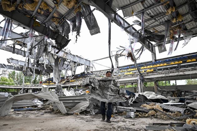 RECORD DATE NOT STATED A worker carries a sheet of corrugated metal while clearing debris at the site of the Favoryt Arena ice sports palace, destroyed in Russian guided aerial bomb (KAB) strikes, in the frontline city of Kherson, Ukraine, on June 3, 2026. The Russian army attacks the city daily with FPV drones and other unmanned aerial vehicles, deliberately terrorizing civilians. Russian forces conduct hunts for local residents, tracking them with FPV drones and dropping explosives. Police officers, medics, public transport, and urban infrastructure are also targeted (Photo by Dmytro Smolienko Ukrinform) Life under shelling in frontline Kherson  Copyright: xDmytroxSmolienkox