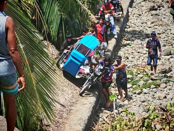 (260611) -- GENERAL SANTOS CITY, June 11, 2026 -- People struggle beside a blocked road after a major landslide triggered by an earthquake, in Sarangani Province, the Philippines, June 11, 2026. At least 47 people were killed, 31 missing and 688 injured after a magnitude 7.8 earthquake struck off the southern coast of Mindanao, the Philippines, on Monday, said the National Disaster Risk Reduction and Management Council (NDRRMC) on Thursday. (Str Xinhua) PHILIPPINES-SARANGANI PROVINCE-EARTHQUAKE-AFTERMATH RouellexUmali 