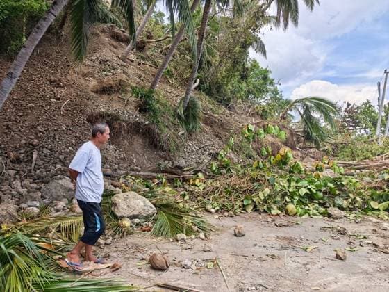 (260611) -- GENERAL SANTOS CITY, June 11, 2026 -- A man stands on a blocked road after a major landslide triggered by an earthquake, in Sarangani Province, the Philippines, June 11, 2026. At least 47 people were killed, 31 missing and 688 injured after a magnitude 7.8 earthquake struck off the southern coast of Mindanao, the Philippines, on Monday, said the National Disaster Risk Reduction and Management Council (NDRRMC) on Thursday. (Str Xinhua) PHILIPPINES-SARANGANI PROVINCE-EARTHQUAKE-AFTERMATH RouellexUmali 