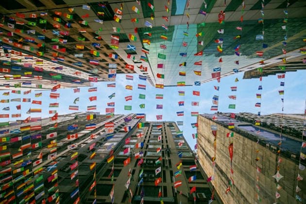 June 11, 2026, Dhaka, Dhaka, Bangladesh: A low-angle view captures thousands of international flags tightly strung across high-rise buildings, completely blanketing the sky over a commercial district in Banani, Dhaka. This massive visual display is part of a city-wide transformation driven by local football enthusiasts celebrating the upcoming FIFA World Cup 2026. Simultaneously, in areas like SwamibagÃ¢â‚¬â ¢s popular FIFA Goli, residents have extensively decorated the neighborhood with elaborate street graffiti, hand-painted murals of global football legends, and painted pavements. These widespread artistic expressions highlight Dhaka s intense football frenzy, turning everyday urban landscapes into colorful cultural landmarks ahead o  - ZUMAa259 20260611_zip_a259_020 Copyright: xRayhanxAhmedx