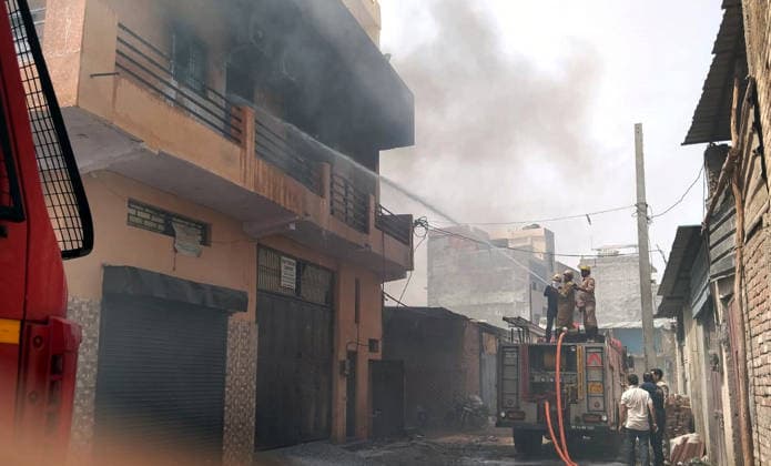 GHAZIABAD, INDIA - JUNE 11: Onlookers watch as firefighters battle fire that erupted at a chemical factory in Hindon Vihar near Nandgram on June 11, 2026 in Ghaziabad, India. (Photo by Sakib Ali Hindustan Times) Massive Fire Broke Out At A Chemical Factory In Ghaziabad