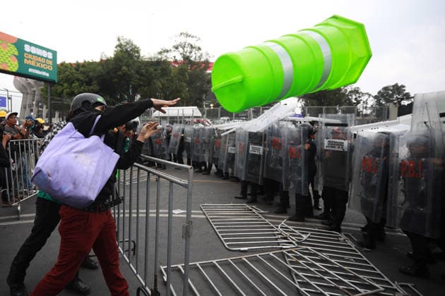 Demonstrators clash with police during the World Cup opener in Mexico City MEXICO CITY, MEXICO - JUNE 11: A protester throws a plastic warning cone at the police as demonstrators clash with riot police near Banorte Stadium during the World Cup opener, in Mexico City, Mexico on June 11, 2026. Thousands of demonstrators marched toward Banorte Stadium to protest against the World Cup, while some clashed with riot police outside the stadium where the World Cup opener was taking place. Daniel Cardenas Anadolu Mexico City Mexico. Editorial use only. Please get in touch for any other usage.  Copyright: x2026xAnadoluxDanielxCardenasx