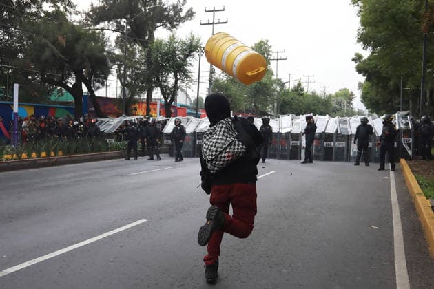 Demonstrators clash with police during the World Cup opener in Mexico City MEXICO CITY, MEXICO - JUNE 11: A protester throws a plastic warning cone at the police as demonstrators clash with riot police near Banorte Stadium during the World Cup opener, in Mexico City, Mexico on June 11, 2026. Thousands of demonstrators marched toward Banorte Stadium to protest against the World Cup, while some clashed with riot police outside the stadium where the World Cup opener was taking place. Daniel Cardenas Anadolu Mexico City Mexico. Editorial use only. Please get in touch for any other usage.  Copyright: x2026xAnadoluxDanielxCardenasx