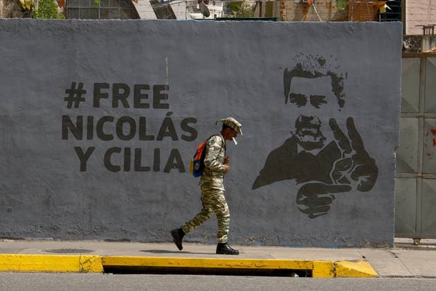 Daily life in Caracas CARACAS, VENEZUELA - JUNE 11: A soldier walks past Maduro’s mural as daily life continues in Caracas while the political shadow of deposed President Nicolas Maduro fades from public consciousness in Caracas, Venezuela, on June 11, 2026. Five months after US forces captured Maduro in a military operation, his once-ubiquitous cult of personality is collapsing; while neglected billboards bearing his face gradually decay along main avenues, murals are being painted over, and ordinary citizens focus on economic survival and community life, effectively pushing the former leader into collective oblivion. Diko Betancourt Anadolu Caracas Venezuela. Editorial use only. Please get in touch for any other usage.  Copyright: x2026xAnadoluxDikoxBetancourtx