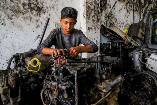 World Day Against Child Labour in Gaza GAZA CITY, GAZA, PALESTINE - JUNE 11: 12-year-old Palestinian Sami Ibrahim Hammad, who lost his father in Israeli attacks on Gaza, works long hours at an auto repair shop to support himself and his family instead of continuing his education during the World Day Against Child Labour on June 12, 2026 in Gaza City, Gaza, Palestine. Khalil Ramzi Alkahlut Anadolu Gaza City Gaza. Editorial use only. Please get in touch for any other usage.  Copyright: x2026xAnadoluxKhalilxRamzixAlkahlutx