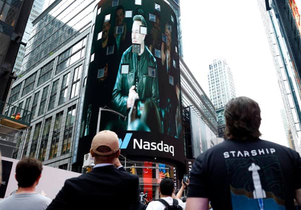 Spectators watch the screens in Times Square showing visuals of Elon Musk and SpaceX Branding at the Nasdaq MarketSite Exchange in Times Square on Friday, June 12, 2026 in New York City. Elon Musk celebrated the Nasdaq opening bell Friday as SpaceX prepared to start trading publicly and possibly cementing his status as a trillionaire.  NYP20260612203 JOHNxANGELILLO