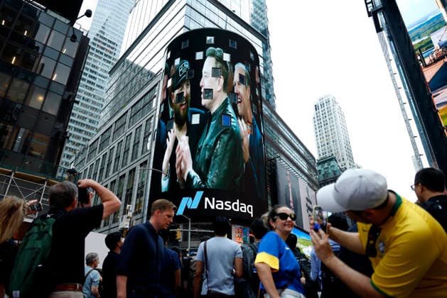 Spectators watch the screens in Times Square showing visuals of Elon Musk and SpaceX branding at the Nasdaq MarketSite Exchange in Times Square on Friday, June 12, 2026 in New York City. Elon Musk celebrated the Nasdaq opening bell Friday as SpaceX prepared to start trading publicly and possibly cementing his status as a trillionaire.  NYP20260612205 JOHNxANGELILLO