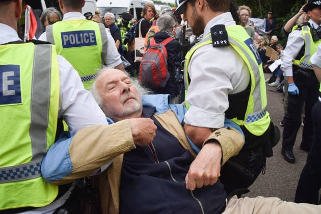 June 12, 2026, London, England, United Kingdom: Police officers arrest a protester who was sitting outside Woolwich Crown Court with a sign stating Ã¢â‚¬ËœSaving lives is not terrorism, I support Palestine ActionÃ¢â‚¬â ¢. Protesters gathered during the sentencing of the activists known as the Filton 4, associated with Palestine Action. The judge will rule whether the activists will be sentenced as terrorists , following their convictions for criminal damage after a direct action at the factory of arms company Elbit Systems in Filton, close to Bristol. London United Kingdom  - ZUMAv130 20260612_zip_v130_009 Copyright: xVukxValcicx