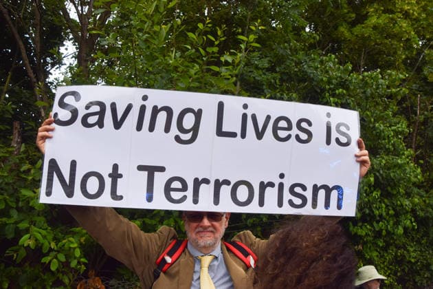 June 12, 2026, London, England, United Kingdom: A protester stands outside Woolwich Crown Court with a sign stating Ã¢â‚¬ËœSaving lives is not terrorismÃ¢â‚¬â ¢. Protesters gathered during the sentencing of the activists known as the Filton 4, associated with Palestine Action. The judge will rule whether the activists will be sentenced as terrorists , following their convictions for criminal damage after a direct action at the factory of arms company Elbit Systems in Filton, close to Bristol. London United Kingdom  - ZUMAv130 20260612_zip_v130_018 Copyright: xVukxValcicx