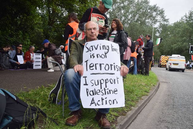 June 12, 2026, London, England, United Kingdom: Protesters sit outside Woolwich Crown Court with signs stating Ã¢â‚¬ËœSaving lives is not terrorism, I support Palestine ActionÃ¢â‚¬â ¢. Protesters gathered during the sentencing of the activists known as the Filton 4, associated with Palestine Action. The judge will rule whether the activists will be sentenced as terrorists , following their convictions for criminal damage after a direct action at the factory of arms company Elbit Systems in Filton, close to Bristol. London United Kingdom - ZUMAv130 20260612_zip_v130_020 Copyright: xVukxValcicx