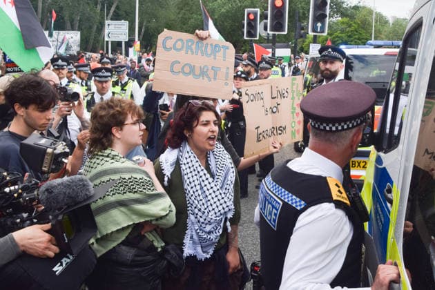 June 12, 2026, London, England, United Kingdom: Protesters confront police officers outside Woolwich Crown Court during the sentencing of the activists known as the Filton 4, associated with Palestine Action. The judge will rule whether the activists will be sentenced as terrorists , following their convictions for criminal damage after a direct action at the factory of arms company Elbit Systems in Filton, close to Bristol. London United Kingdom  - ZUMAv130 20260612_zip_v130_053 Copyright: xVukxValcicx