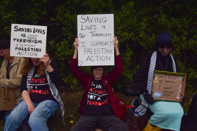 June 12, 2026, London, England, United Kingdom: Protesters sit outside Woolwich Crown Court with signs stating Ã¢â‚¬ËœSaving lives is not terrorism, I support Palestine ActionÃ¢â‚¬â ¢. Protesters gathered during the sentencing of the activists known as the Filton 4, associated with Palestine Action. The judge will rule whether the activists will be sentenced as terrorists , following their convictions for criminal damage after a direct action at the factory of arms company Elbit Systems in Filton, close to Bristol. London United Kingdom - ZUMAv130 20260612_zip_v130_050 Copyright: xVukxValcicx