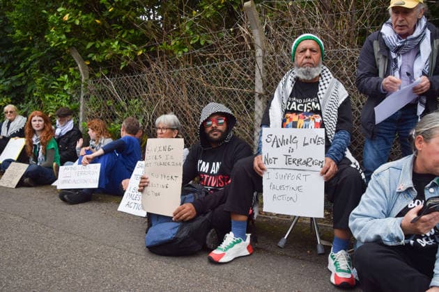 June 12, 2026, London, England, United Kingdom: Protesters sit outside Woolwich Crown Court with signs stating Ã¢â‚¬ËœSaving lives is not terrorism, I support Palestine ActionÃ¢â‚¬â ¢. Protesters gathered during the sentencing of the activists known as the Filton 4, associated with Palestine Action. The judge will rule whether the activists will be sentenced as terrorists , following their convictions for criminal damage after a direct action at the factory of arms company Elbit Systems in Filton, close to Bristol. London United Kingdom - ZUMAv130 20260612_zip_v130_054 Copyright: xVukxValcicx