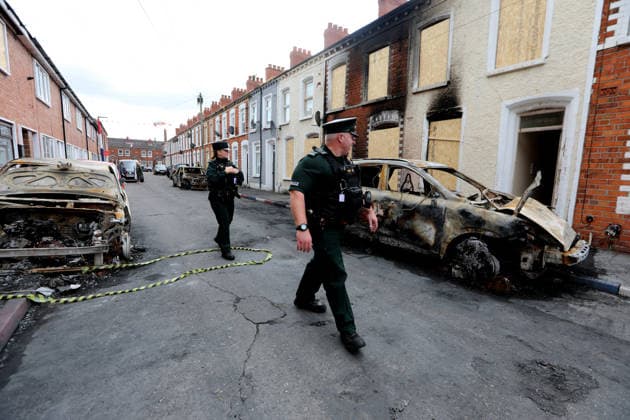 Aftermath of the race riots in Belfast BELFAST, NORTHERN IRELAND - JUNE 12: Police walk between the burned cars on the street as a clean-up operation is under way after a race riots erupted in Belfast, Northern Ireland, on June 12, 2026. Twelve police officers were injured and 27 people made homeless during two nights of unrest. Conor McCaughley Anadolu Belfast Northern Ireland. Editorial use only. Please get in touch for any other usage.  Copyright: x2026xAnadoluxConorxMcCaughleyx