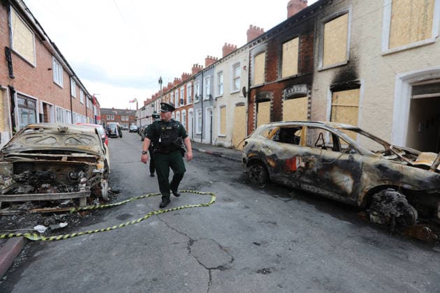 Aftermath of the race riots in Belfast BELFAST, NORTHERN IRELAND - JUNE 12: Police walk among the burned cars on the street as a clean-up operation is under way after a race riots erupted in Belfast, Northern Ireland, on June 12, 2026. Twelve police officers were injured and 27 people made homeless during two nights of unrest. Conor McCaughley Anadolu Belfast Northern Ireland. Editorial use only. Please get in touch for any other usage.  Copyright: x2026xAnadoluxConorxMcCaughleyx