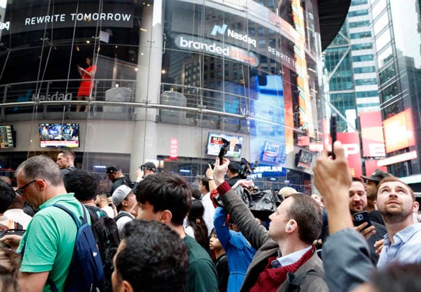 Spectators watch the screens in Times Square showing visuals of Elon Musk and SpaceX branding at the Nasdaq MarketSite Exchange in Times Square on Friday, June 12, 2026 in New York City. Elon Musk celebrated the Nasdaq opening bell Friday as SpaceX prepared to start trading publicly and possibly cementing his status as a trillionaire.  NYP20260612213 JOHNxANGELILLO