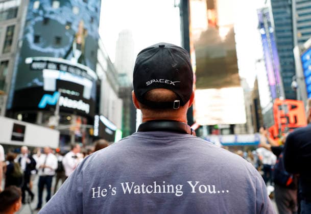 Spectators watch the screens in Times Square showing visuals of Elon Musk and SpaceX branding at the Nasdaq MarketSite Exchange in Times Square on Friday, June 12, 2026 in New York City. Elon Musk celebrated the Nasdaq opening bell Friday as SpaceX prepared to start trading publicly and possibly cementing his status as a trillionaire.  NYP20260612214 JOHNxANGELILLO