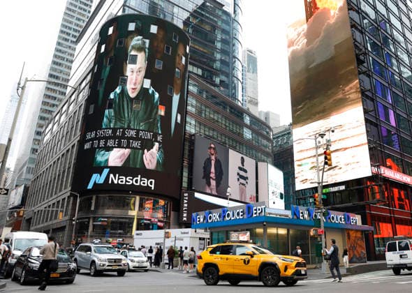Spectators watch the screens in Times Square showing visuals of Elon Musk and SpaceX branding at the Nasdaq MarketSite Exchange in Times Square on Friday, June 12, 2026 in New York City. Elon Musk celebrated the Nasdaq opening bell Friday as SpaceX prepared to start trading publicly and possibly cementing his status as a trillionaire.  NYP20260612217 JOHNxANGELILLO