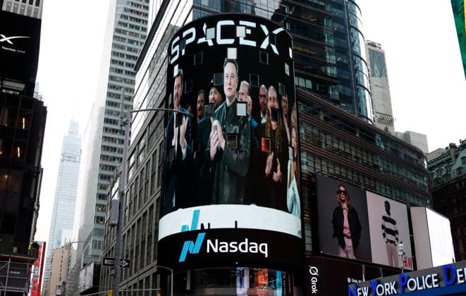 Spectators watch the screens in Times Square showing visuals of Elon Musk and SpaceX branding at the Nasdaq MarketSite Exchange in Times Square on Friday, June 12, 2026 in New York City. Elon Musk celebrated the Nasdaq opening bell Friday as SpaceX prepared to start trading publicly and possibly cementing his status as a trillionaire.  NYP20260612219 JOHNxANGELILLO