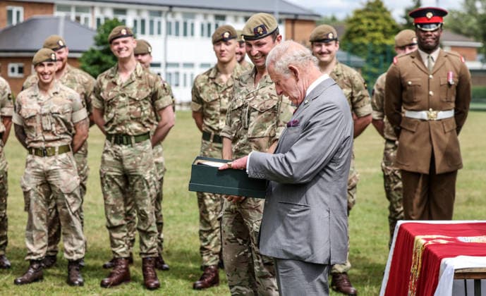 . 12 06 2026. Aldershot, United Kingdom. King Charles III is presented with a a pair of hand made slippers during a visit to the Grenadier Guards at Lille Barracks in Aldershot, United Kingdom.  xPoolx xi-Imagesx IIM-26828-0019