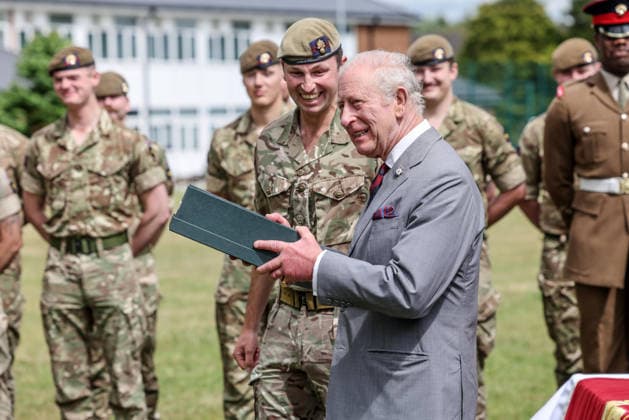 . 12 06 2026. Aldershot, United Kingdom. King Charles III is presented with a a pair of hand made slippers during a visit to the Grenadier Guards at Lille Barracks in Aldershot, United Kingdom.  xPoolx xi-Imagesx IIM-26828-0020