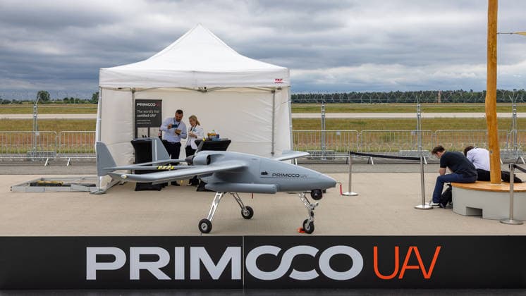 Fachbesuchertag auf ILA Berlin 2026, Berlin, 12.06.2026 Ein unbemanntes Luftfahrzeug (UAV) des tschechischen Herstellers Primoco UAV steht auf dem Ausstellungsgelände. Das Modell wird laut Standschild als weltweit erster zertifizierter UAV mit NATO-STANAG- und EASA-Zulassung beworben. Im Hintergrund zwei Standmitarbeiter im Gespräch. Schöneberg Berlin ExpoCenter Airport Brandenburg Deutschland *** Trade visitor day at ILA Berlin 2026, Berlin, 12 06 2026 An unmanned aerial vehicle UAV from the Czech manufacturer Primoco UAV stands on the exhibition grounds The model is advertised as the worlds first certified UAV with NATO STANAG and EASA approval according to the stand sign In the background, two stand employees in conversation Schöneber 20260612-286A9704-M4000