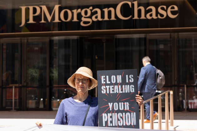 June 12, 2026, New York, New York, USA: A coalition of organizations rally outside JP Morgan Chase headquarters in Midtown Manhattan to disrupt Chase CEO J. Dimon s party celebrating E. Musk s launch of SpaceX s IPO on the Nasdaq Stock Exchange and Musk s net worth as a trillionaire. A protester holds a sign that reads ELON IS STEALING YOUR PENSION. Organizers denounce working people having SpaceX forced into their 401ks and pensions and the emergence of trillionaire-level wealth in the United States while millions of people face housing insecurity, medical debt, and low wages. New York USA - ZUMAr174 20260612_znp_r174_008 Copyright: xGinaxMxRandazzox