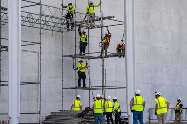 Construction workers build a scaffolding near the sign for the Donald J. Trump and The John F. Kennedy Memorial Center for the Performing Arts in Washington, DC on Friday, June 12, 2026. The Kennedy Center board voted to seek an emergency appeal to block a court order requiring the removal of President Trump s name from the Kennedy Center, but a judge denied their request.  WAP20260612407 BONNIExCASH