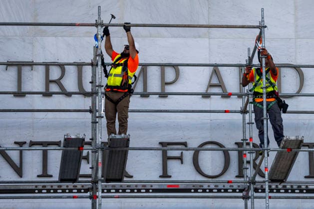 Construction workers build a scaffolding near the sign for the Donald J. Trump and The John F. Kennedy Memorial Center for the Performing Arts in Washington, DC on Friday, June 12, 2026. The Kennedy Center board voted to seek an emergency appeal to block a court order requiring the removal of President Trump s name from the Kennedy Center, but a judge denied their request.  WAP20260612421 BONNIExCASH