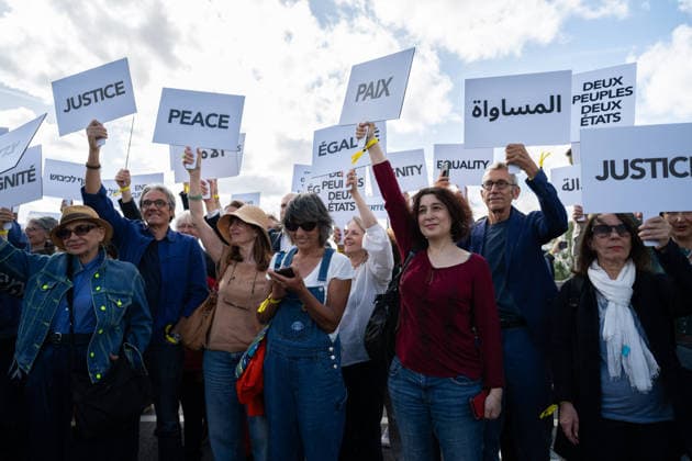 Press conference during the Paris Call for the Two-State Solution - Paris Participants of the Paris Call for the Two-State Solution with Israeli and Palestinian civil society groups carry placards on the Pont de La Tournelle birdge with the Notre-Dame de Paris Cathedral in the background in Paris, France on June 12, 2026. France is hosting this international meeting, attended by ministers from Brazil, Canada, the United Arab Emirates and Turkey, as well as the EU s High Representative for Foreign Affairs, following its recognition of the State of Palestine in 2025. French Foreign Minister reiterated Paris support for the two-state solution, stating that this year could be decisive at the close of the conference. Photo by Gregoire Campion  Copyright: xCampionexGregoire Pool ABACAx