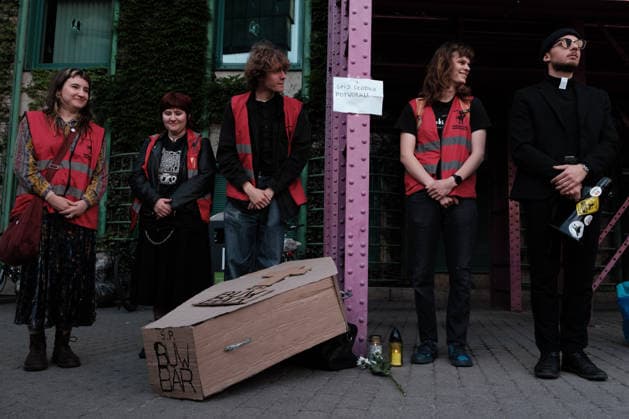 June 12, 2026, Warsaw, Masovian Voivodeship, Poland: Student activists gather outside the University of Warsaw library during the start of a mock funeral procession doubling as a students demonstration welcoming the recent closure of the University of Warsaw s premium food hall, BUWBAR, located in the main library on campus. The establishment closed suddenly after only a month of operation following intense protests by students, who were promised an affordable student s canteen by the university s rector but were instead given an expensive food hall offering premium meals beyond student budgets. The paper sign hanging above the cardboard coffin reads sleep tight, little monster. Warsaw Poland - ZUMAk204 20260612_zip_k204_011 Copyright: xRomanxKozielx