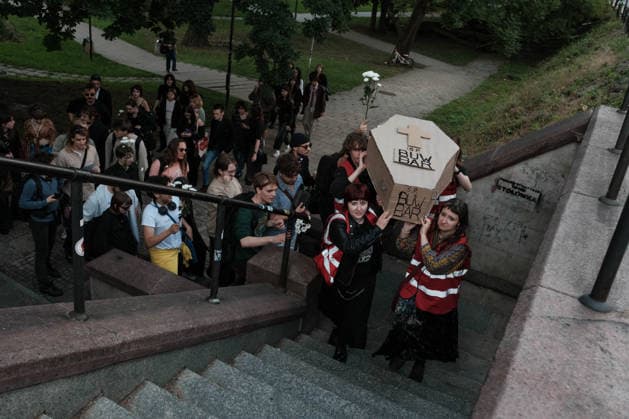 June 12, 2026, Warsaw, Masovian Voivodeship, Poland: Student activists carry a symbolic cardboard coffin and white flowers during a mock funeral procession doubling as a students demonstration welcoming the recent closure of the University of Warsaw s premium food hall, BUWBAR, located in the main library on campus. The establishment closed suddenly after only a month of operation following intense protests by students, who were promised an affordable student s canteen by the university s rector but were instead given an expensive food hall offering premium meals beyond student budgets. Warsaw Poland - ZUMAk204 20260612_zip_k204_017 Copyright: xRomanxKozielx