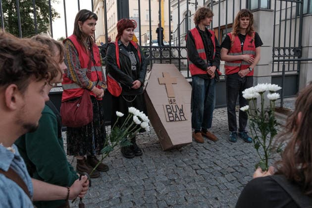 June 12, 2026, Warsaw, Masovian Voivodeship, Poland: Student activists with a symbolic cardboard coffin and white flowers during a mock funeral procession doubling as a students demonstration welcoming the recent closure of the University of Warsaw s premium food hall, BUWBAR, located in the main library on campus. The establishment closed suddenly after only a month of operation following intense protests by students, who were promised an affordable student s canteen by the university s rector but were instead given an expensive food hall offering premium meals beyond student budgets. Warsaw Poland - ZUMAk204 20260612_zip_k204_018 Copyright: xRomanxKozielx