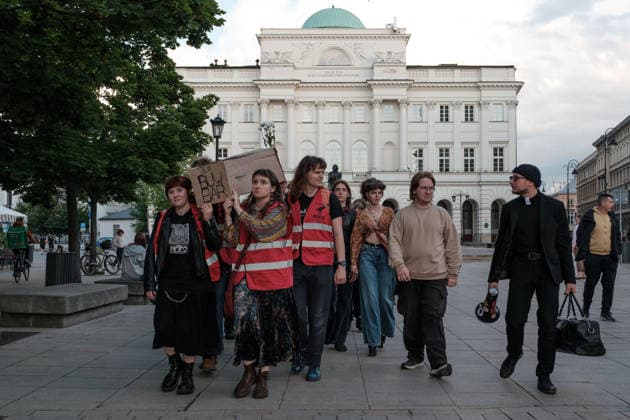 June 12, 2026, Warsaw, Masovian Voivodeship, Poland: Student activists carry a symbolic cardboard coffin and white flowers during a mock funeral procession doubling as a students demonstration welcoming the recent closure of the University of Warsaw s premium food hall, BUWBAR, located in the main library on campus. The establishment closed suddenly after only a month of operation following intense protests by students, who were promised an affordable student s canteen by the university s rector but were instead given an expensive food hall offering premium meals beyond student budgets. Warsaw Poland - ZUMAk204 20260612_zip_k204_021 Copyright: xRomanxKozielx