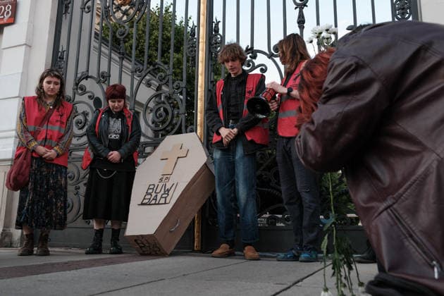 June 12, 2026, Warsaw, Masovian Voivodeship, Poland: Student activists with a symbolic cardboard coffin in front of the closed gates of the University of Warsaw main campus during a mock funeral procession doubling as a students demonstration welcoming the recent closure of the University of Warsaw s premium food hall, BUWBAR, located in the main library on campus. The establishment closed suddenly after only a month of operation following intense protests by students, who were promised an affordable student s canteen by the university s rector but were instead given an expensive food hall offering premium meals beyond student budgets. Warsaw Poland - ZUMAk204 20260612_zip_k204_026 Copyright: xRomanxKozielx